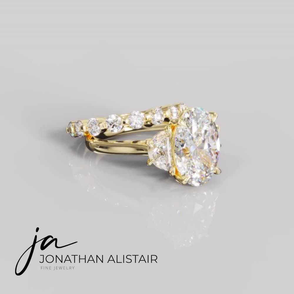 The Drakensberg — a yellow gold bridal pair featuring an oval three-stone engagement ring and matching shared-prong diamond band, custom commission by Jonathan Alistair