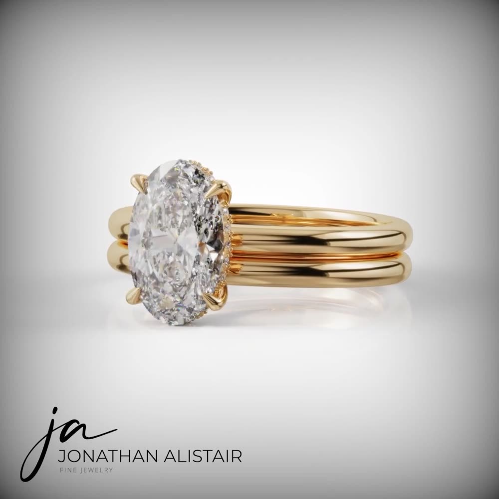 The Winelands — a yellow gold oval diamond engagement ring with hidden halo and a stacked matching band, custom commission by Jonathan Alistair